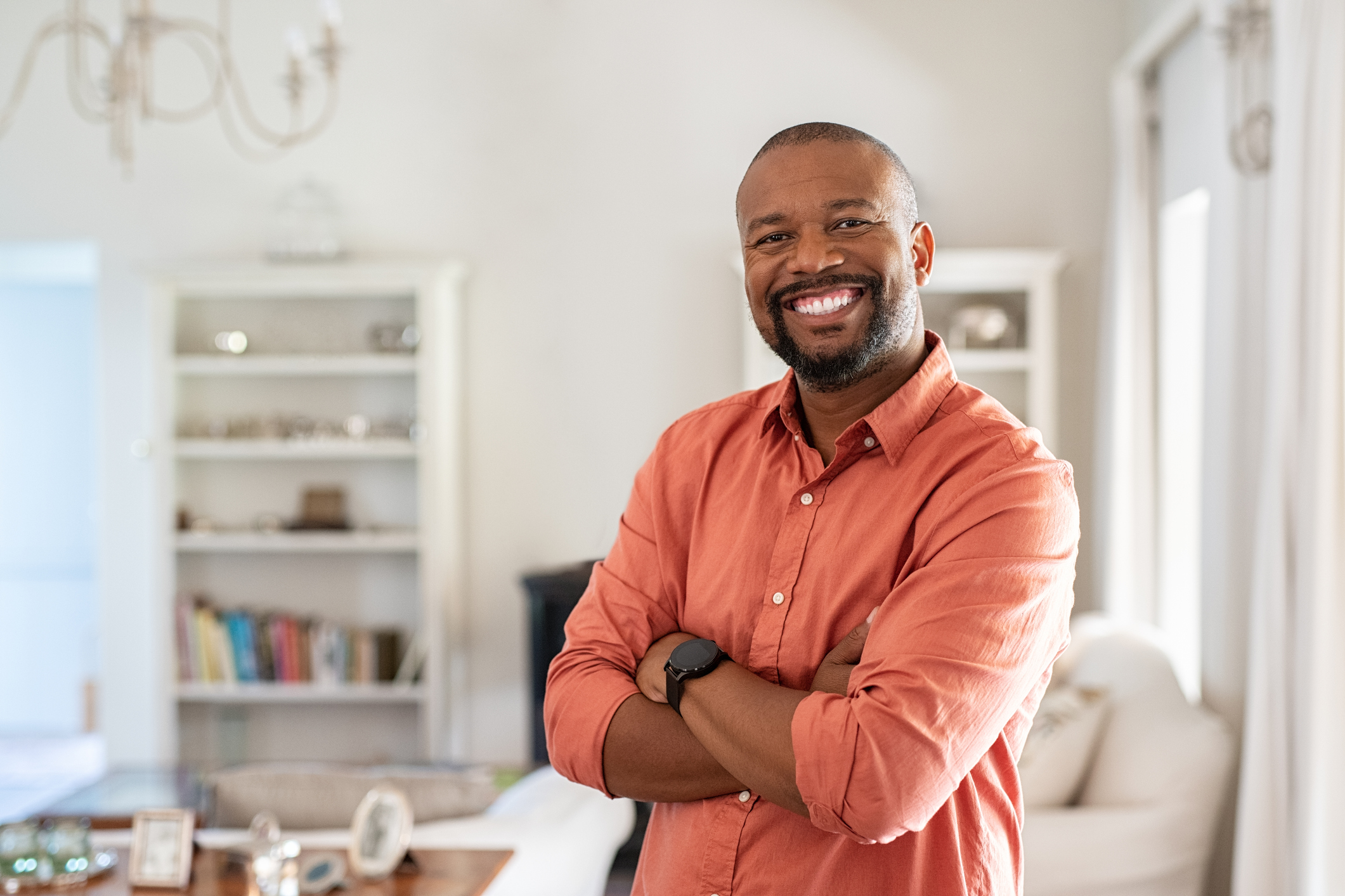 Man with beard standing with crossed arms