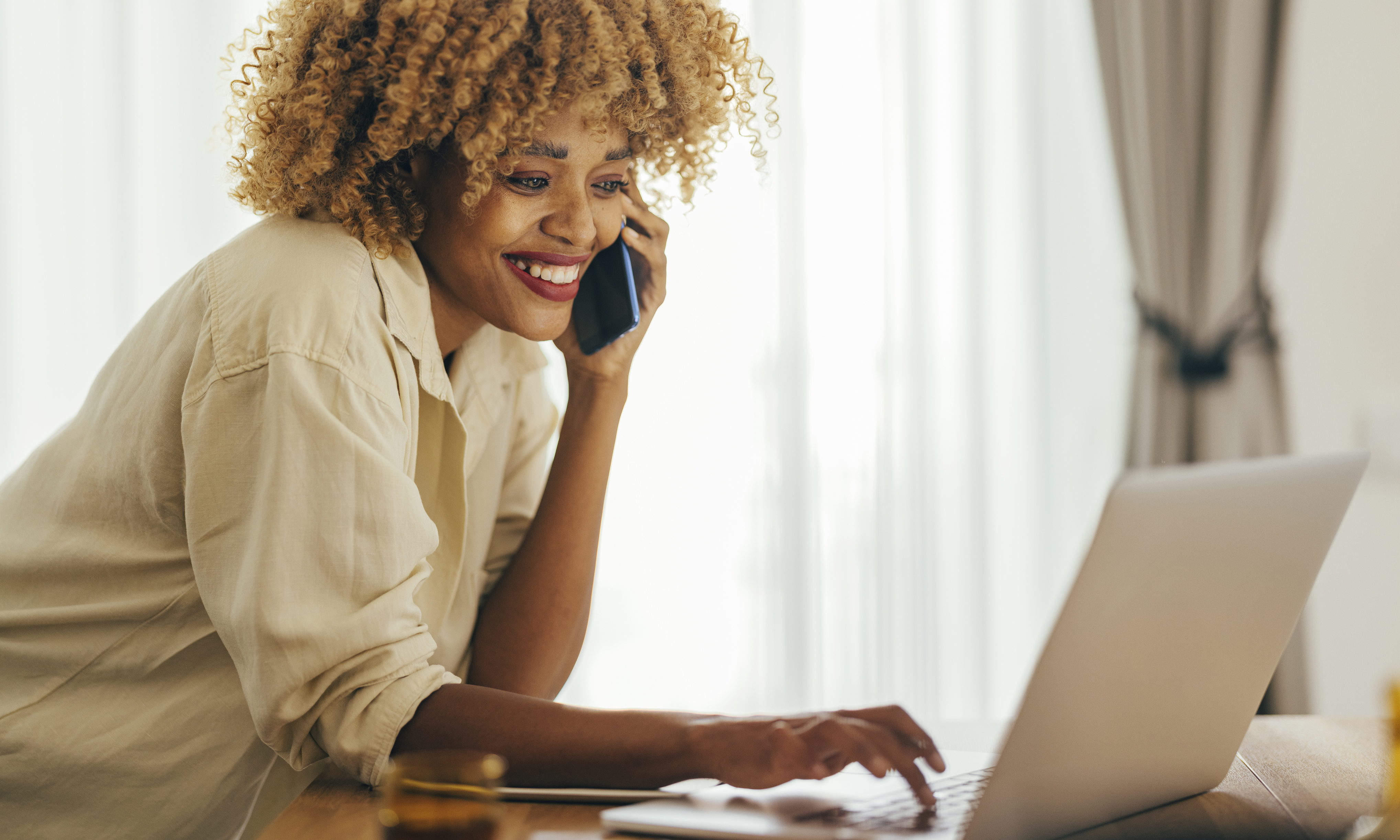 Smiling woman makes a phone call